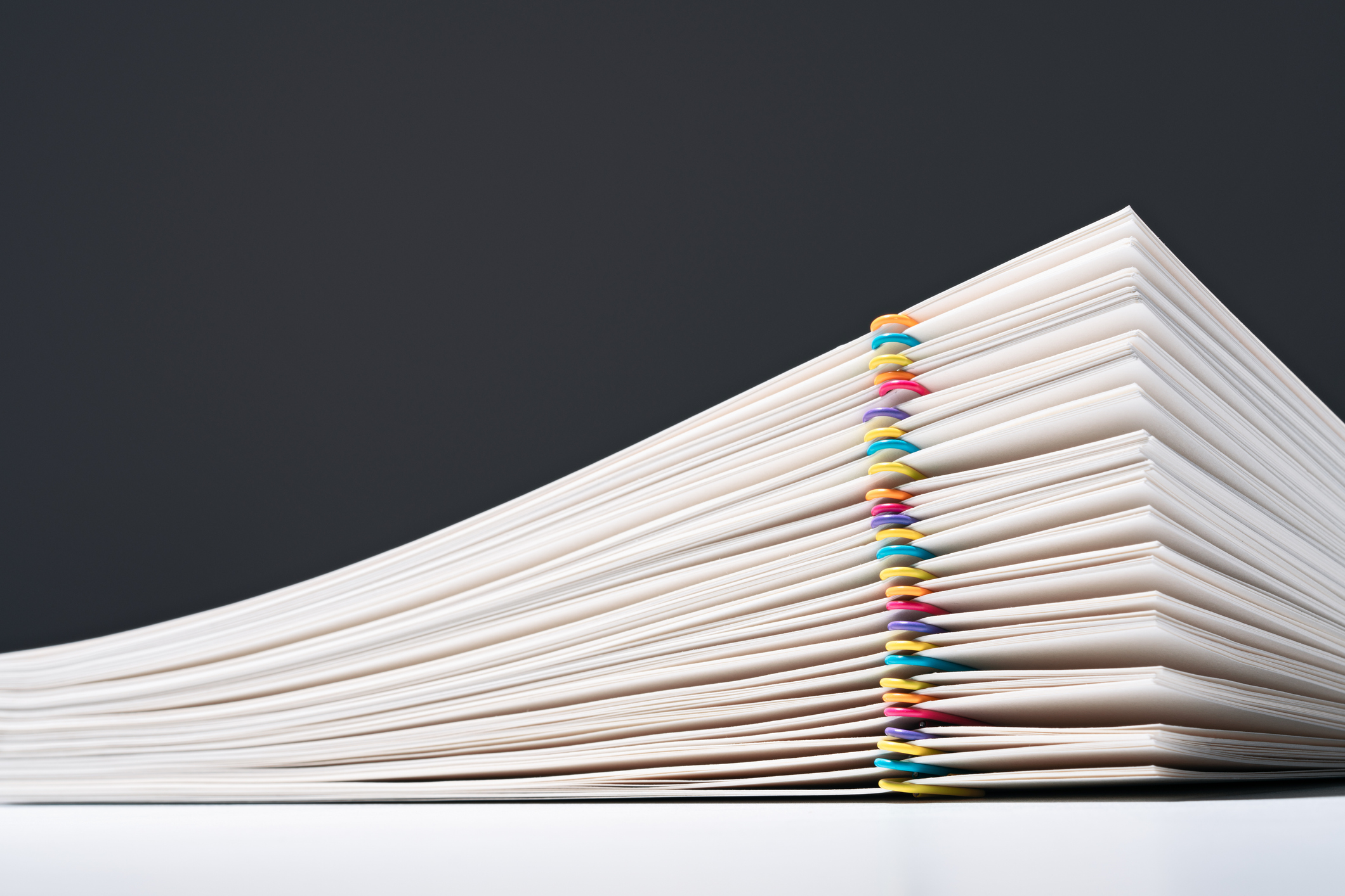 stacked-paper-files-with-colorful-paper-clips